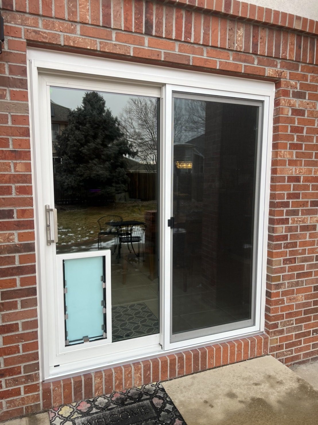 White Smart Tech 7500 Series sliding patio door with a Hale pet door in the glass