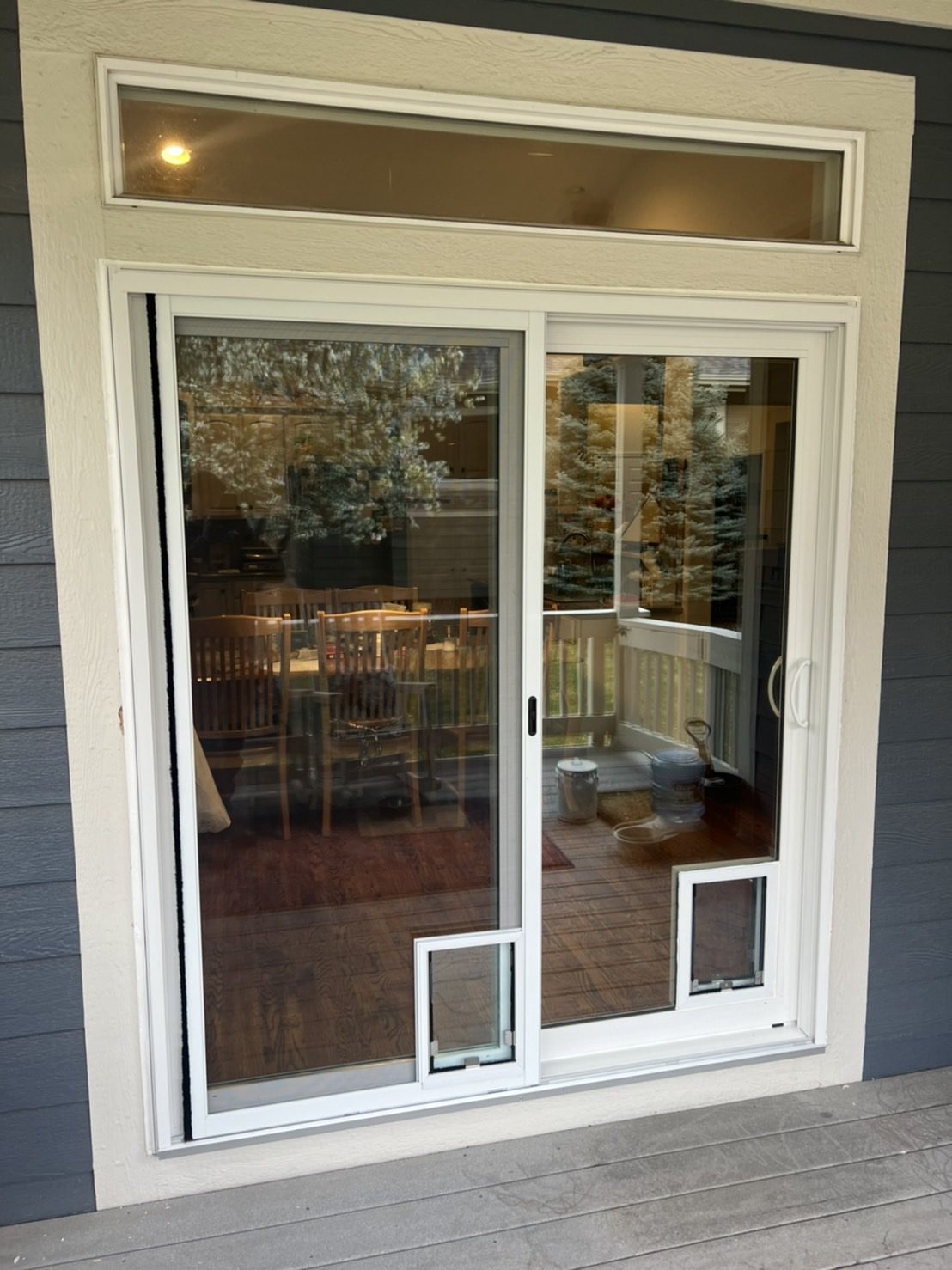 White Smart Tech 7500 Series sliding patio door with a Hale pet door in the glass