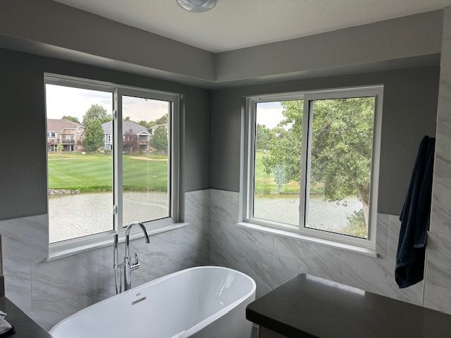 White Smart Tech sliding windows with tempered glass in a master bathroom