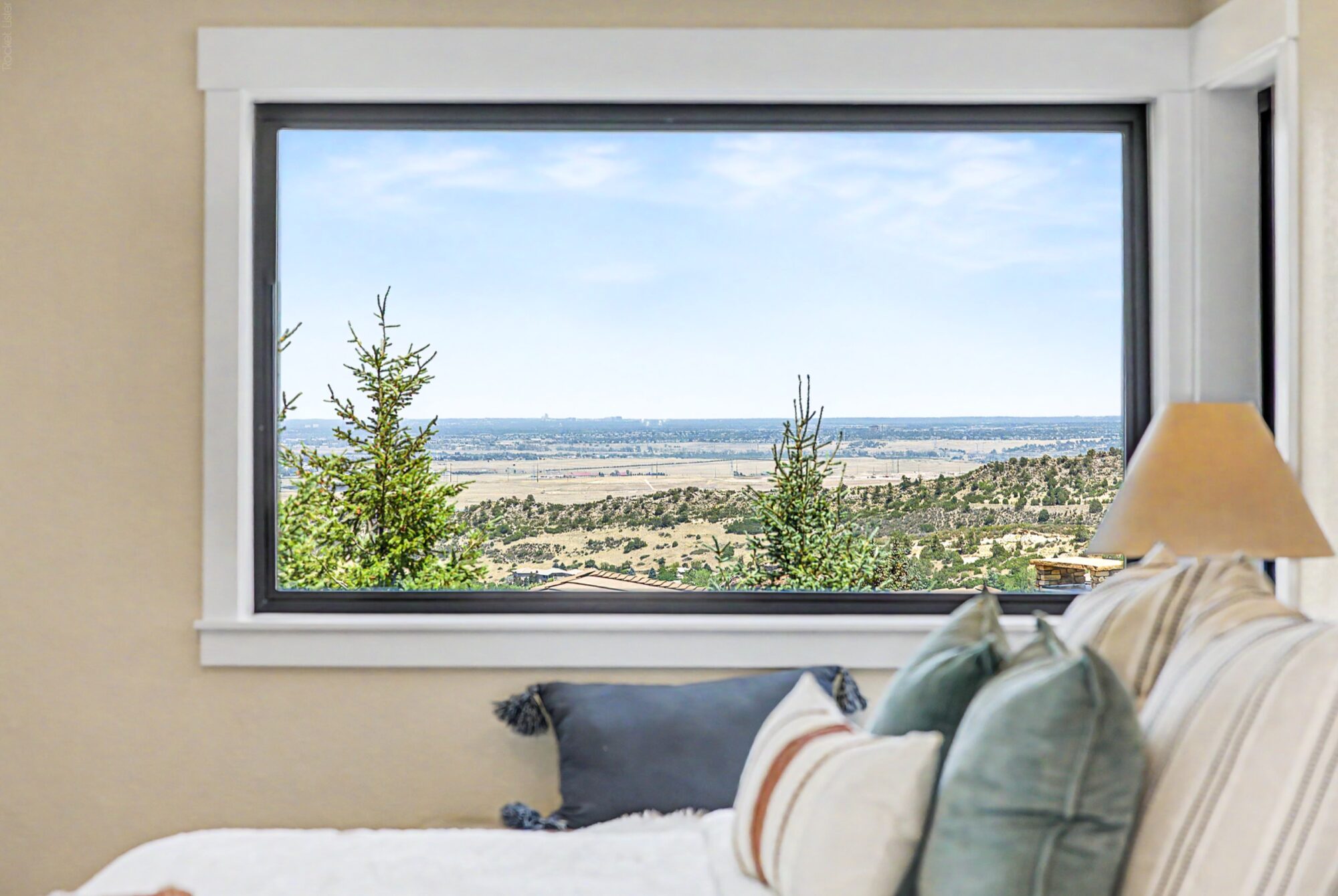 Jet Black Win-Dor 1750 Series fixed picture window in a bedroom with white trim, interior view.