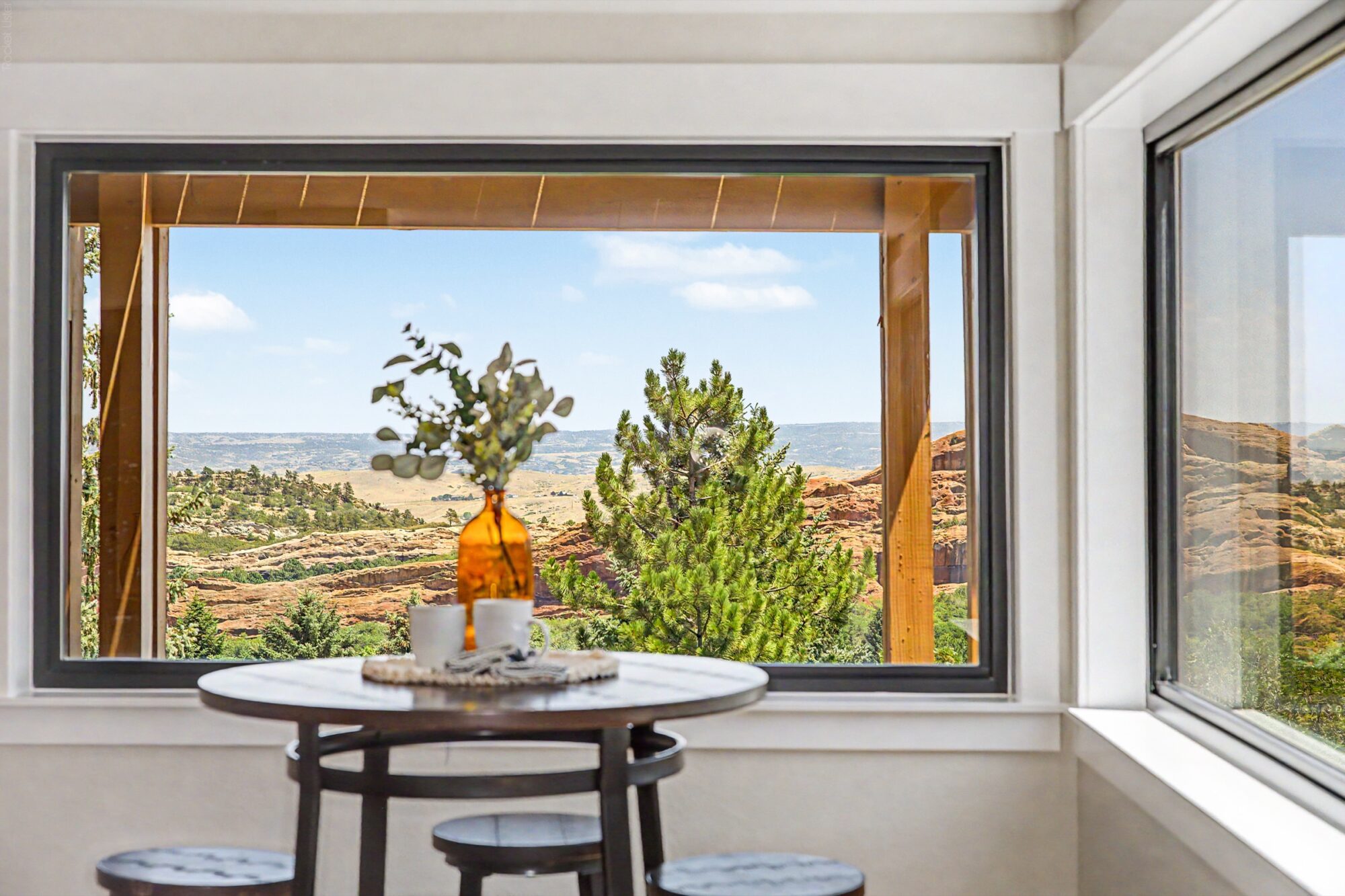 Jet Black Win-Dor 1750 Series fixed picture window in a dining nook, interior view.