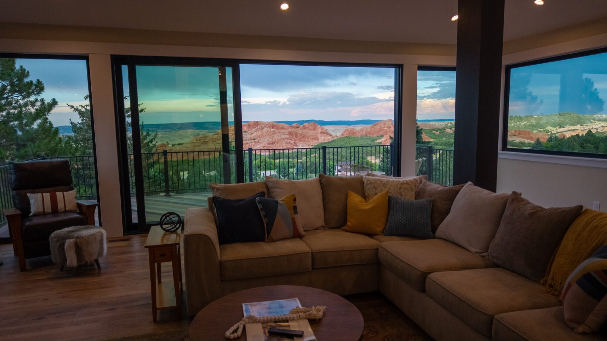 Jet Black Win-Dor 3750 Series sliding patio door and picture windows in a living room at dusk, interior view.