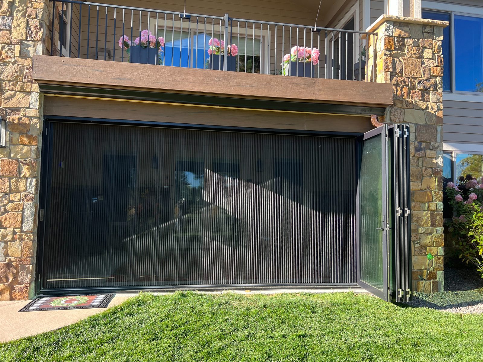 Black Win-Dor folding patio door with a Genius retractable pleated screen closed