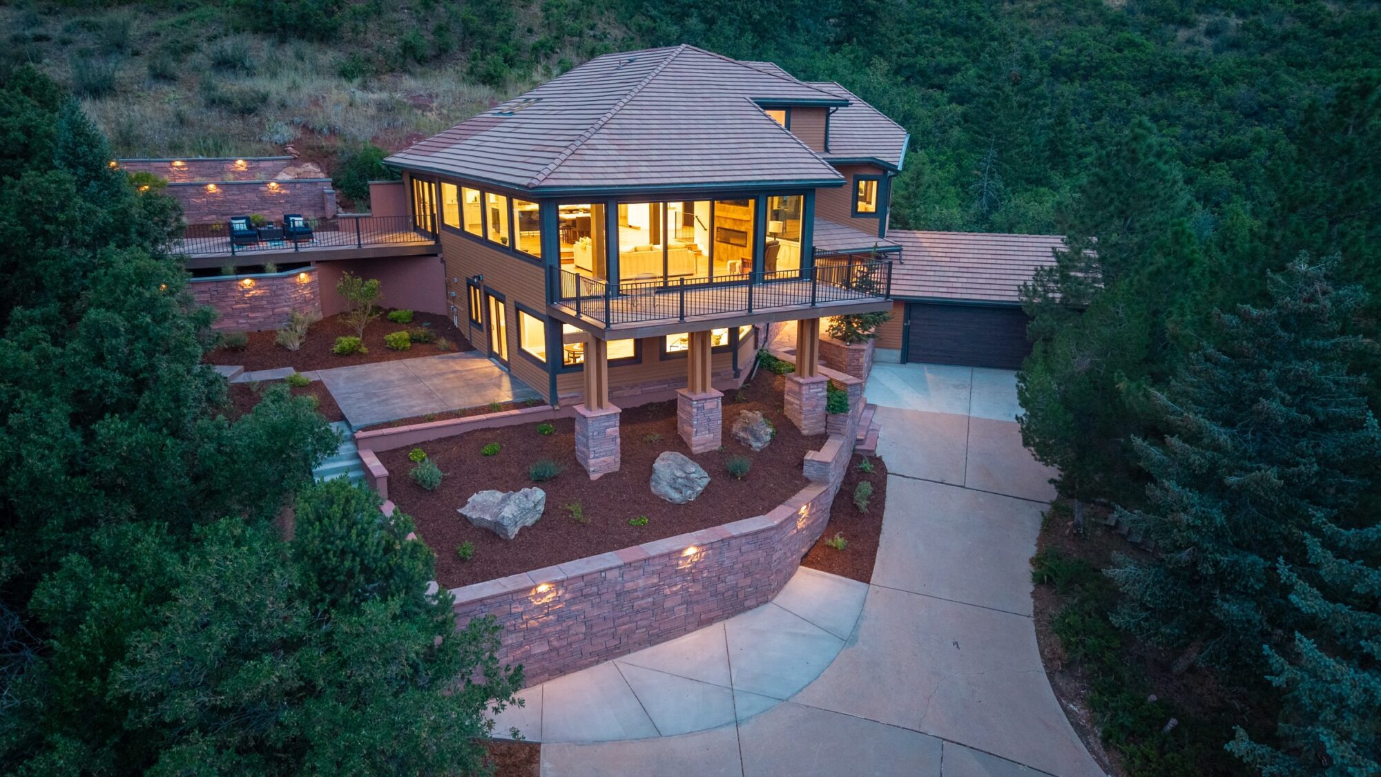 Aerial dusk view of a hillside home with Jet Black Win-Dor windows and sliding patio door on both levels.