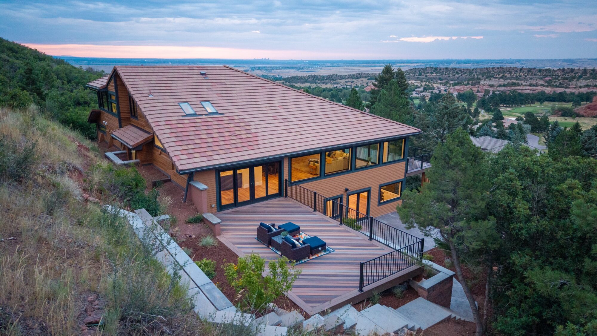 Aerial dusk view of the rear deck with a row of Jet Black Win-Dor 1750 Series windows.