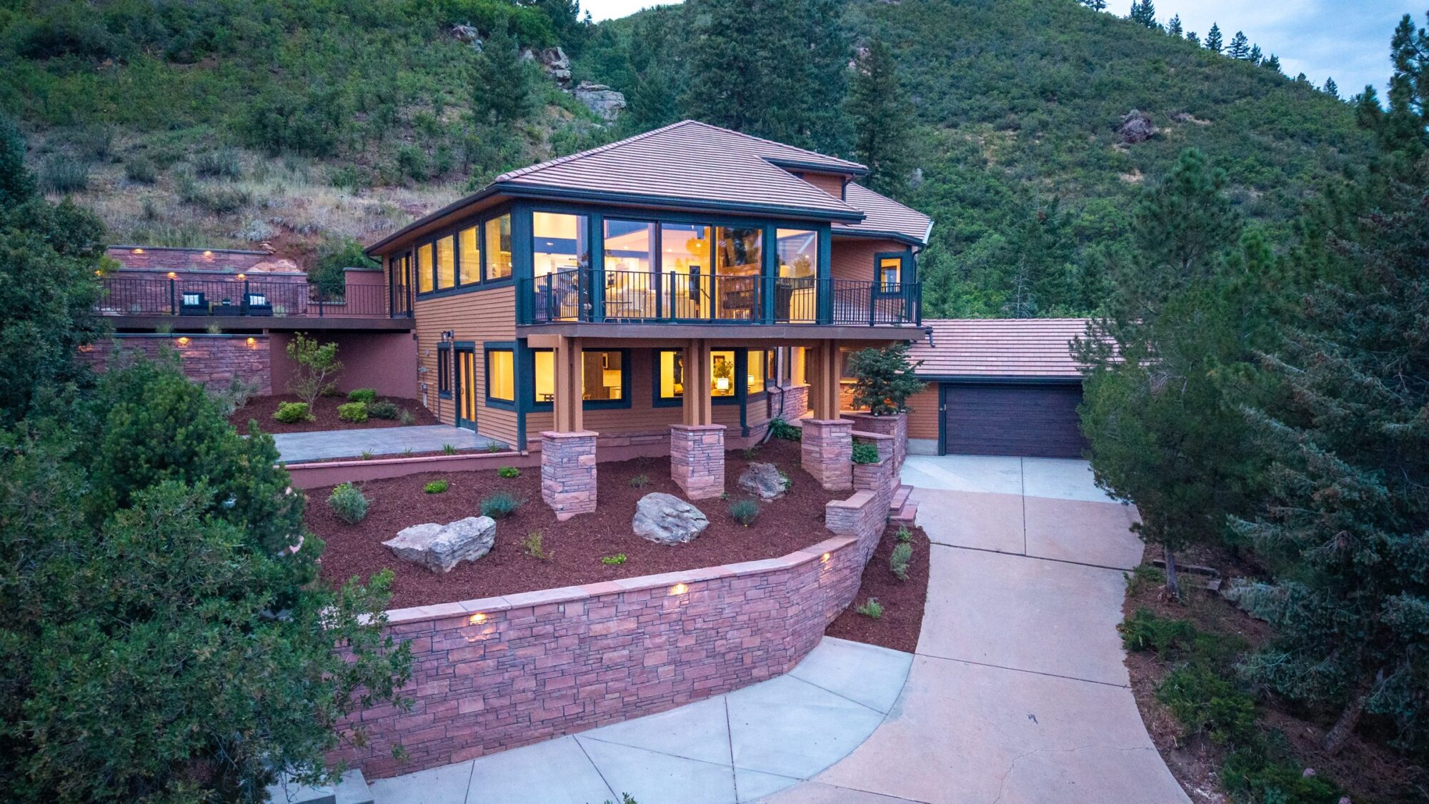 Aerial dusk view of a home front with Jet Black Win-Dor windows and a 3750 Series sliding patio door.