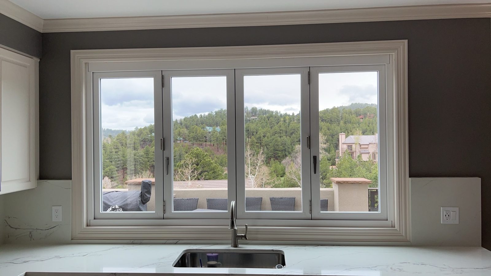 White Win-Dor bifold window closed, seen from inside the kitchen